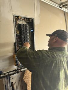 Electrician inspecting residential electrical panel