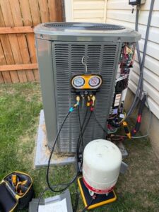 HVAC unit with manifold gauges and tools