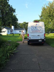 White service van and technician on driveway